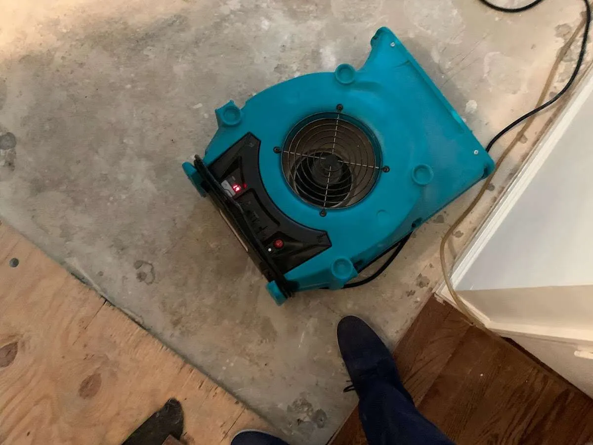 Air mover drying subfloor during Commercial Water Damage Restoration in Hermantown